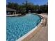 Community pool featuring a splash fountain, with plenty of lounge chairs around the pool at 2956 Lucayan Harbour Cir # 108, Kissimmee, FL 34746