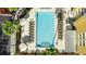 Aerial view of a pool surrounded by palm trees and lounge chairs at resort at 3000 Maingate Ln # 520, Kissimmee, FL 34747