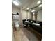 Modern bathroom with dual sinks, elegant black countertop, and well-lit mirror, exuding style at 3000 Maingate Ln # 520, Kissimmee, FL 34747
