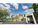 Galleria Palms Hotel sign with well-manicured landscaping and clear blue skies at 3000 Maingate Ln # 520, Kissimmee, FL 34747