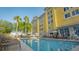Inviting resort pool with lounge chairs and palm trees against the hotel at 3000 Maingate Ln # 520, Kissimmee, FL 34747