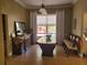 Elegant dining room with a large wood table, comfortable seating, and a stylish buffet against a neutral-toned wall at 3150 Appaloosa Ct, Kissimmee, FL 34746