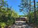 Gated driveway entrance surrounded by lush greenery, offering privacy and a grand sense of arrival at 3150 Appaloosa Ct, Kissimmee, FL 34746
