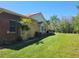 Lovely home featuring a brick exterior, palm tree, and a well-manicured lawn under a clear blue sky at 3150 Appaloosa Ct, Kissimmee, FL 34746