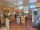 Spacious kitchen with custom cabinets, tile floors, a central island and modern stainless steel appliances at 3150 Appaloosa Ct, Kissimmee, FL 34746