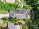 Aerial shot of home highlighting the well-maintained roof, backyard deck, and lush greenery providing a private outdoor space at 322 N Rhodes St, Mount Dora, FL 32757
