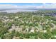 Expansive aerial view of the community showcasing the close proximity to the lake and tree-lined neighborhoods at 322 N Rhodes St, Mount Dora, FL 32757