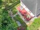 The backyard's aerial view highlights a deck, a fire pit, a pergola, and lush surroundings providing privacy and outdoor enjoyment at 322 N Rhodes St, Mount Dora, FL 32757