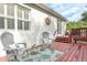 Spacious back deck is furnished with chairs and overlooks wooded lot at 322 N Rhodes St, Mount Dora, FL 32757
