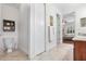 Hallway to a bathroom featuring tile floors and toilet at 322 N Rhodes St, Mount Dora, FL 32757
