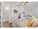 Bedroom featuring hardwood floors, a ceiling fan and two twin beds at 322 N Rhodes St, Mount Dora, FL 32757