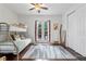 Bedroom featuring a bunk bed, wood floors, ceiling fan, and outdoor access at 322 N Rhodes St, Mount Dora, FL 32757