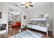 Bedroom featuring hardwood floors, a bunkbed, and view to living area at 322 N Rhodes St, Mount Dora, FL 32757