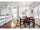 Inviting dining area adjacent to the kitchen, featuring a wooden table, chandelier, and abundant natural light at 322 N Rhodes St, Mount Dora, FL 32757