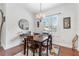 Cozy dining room with a wooden table, chandelier, and a bright window, perfect for Gathering gatherings at 322 N Rhodes St, Mount Dora, FL 32757