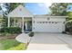 Charming single-story home showcasing a well-maintained lawn and a welcoming front porch with a double-door entry at 322 N Rhodes St, Mount Dora, FL 32757