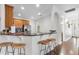 Breakfast bar features granite counters, wooden cabinets, and seating for three at 322 N Rhodes St, Mount Dora, FL 32757