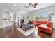 Open-concept living room with hardwood floors, ceiling fan, and natural light at 322 N Rhodes St, Mount Dora, FL 32757