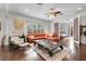 Spacious living room with hardwood floors, a ceiling fan, and a large window at 322 N Rhodes St, Mount Dora, FL 32757
