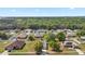 Aerial view of home in neighborhood with mature trees at 328 Woodland Trl, Lady Lake, FL 32159