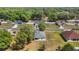 An aerial view of a single story home in a neighborhood with beautiful landscaping at 328 Woodland Trl, Lady Lake, FL 32159