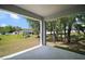 Covered patio with expansive backyard view and mature trees creates a peaceful outdoor living space at 328 Woodland Trl, Lady Lake, FL 32159