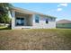 Exterior of home with covered back patio and large backyard at 328 Woodland Trl, Lady Lake, FL 32159