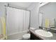 Bathroom with shower over tub, granite countertop vanity and tile surround at 328 Woodland Trl, Lady Lake, FL 32159