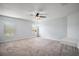Large bedroom with carpet and two windows with blinds at 328 Woodland Trl, Lady Lake, FL 32159