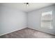 Empty bedroom featuring carpet, window with blinds, and neutral paint at 328 Woodland Trl, Lady Lake, FL 32159