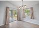 Bright dining area with sliding glass doors and wood-look floors provides access to the outdoor space at 328 Woodland Trl, Lady Lake, FL 32159