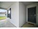 Front porch with black door and window with shutters at 328 Woodland Trl, Lady Lake, FL 32159