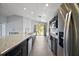 Well-appointed kitchen with stainless steel appliances, granite countertops, and an island with a sink at 328 Woodland Trl, Lady Lake, FL 32159