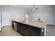 Modern kitchen with a granite island, stainless-steel appliances, and ample storage is open to the living area at 328 Woodland Trl, Lady Lake, FL 32159