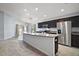 Modern kitchen features a large island, stainless appliances, and dark wood cabinetry at 328 Woodland Trl, Lady Lake, FL 32159