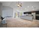 Bright open-concept living space flows into the kitchen, featuring modern lighting and neutral tones at 328 Woodland Trl, Lady Lake, FL 32159
