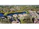 Aerial view of a community with serene lakes, lush trees, and well-maintained houses nestled in nature at 3687 Farm Bell Pl, Lake Mary, FL 32746