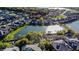 A captivating aerial view of upscale homes surrounding a tranquil lake at 3687 Farm Bell Pl, Lake Mary, FL 32746