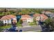 Aerial shot of homes with terra cotta roofs, lush landscaping, and private lake access at 3687 Farm Bell Pl, Lake Mary, FL 32746