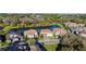 Aerial view showcasing the neighborhood's lake, lush landscaping, and variety of homes at 3687 Farm Bell Pl, Lake Mary, FL 32746