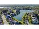 Scenic aerial view of a residential area with a lake surrounded by beautiful homes at 3687 Farm Bell Pl, Lake Mary, FL 32746