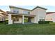 Spacious backyard with a covered patio featuring sliding glass doors and green lawn for outdoor activities at 3687 Farm Bell Pl, Lake Mary, FL 32746