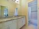 Bathroom featuring a dual-sink vanity with granite countertops and a tub shower at 3687 Farm Bell Pl, Lake Mary, FL 32746