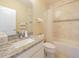 Bathroom featuring a vanity with a granite countertop and a shower-tub combo at 3687 Farm Bell Pl, Lake Mary, FL 32746