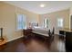 Bright bedroom with hardwood floors, plantation shutters, and private balcony access at 3687 Farm Bell Pl, Lake Mary, FL 32746