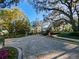 Elegant gated community entrance with lush landscaping and brick paver driveway at 3687 Farm Bell Pl, Lake Mary, FL 32746