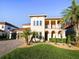 Beautiful two-story home with a barrel tile roof, front lawn, and brick paver driveway at 3687 Farm Bell Pl, Lake Mary, FL 32746