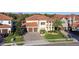 Stately two-story home featuring a tile roof, twin garages, and a well-manicured lawn with mature landscaping at 3687 Farm Bell Pl, Lake Mary, FL 32746