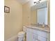Well-lit half bathroom featuring granite countertop, vanity, and modern fixtures at 3687 Farm Bell Pl, Lake Mary, FL 32746