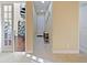 Bright hallway with tile flooring, neutral walls, and doorway leading to a spiral staircase at 3687 Farm Bell Pl, Lake Mary, FL 32746
